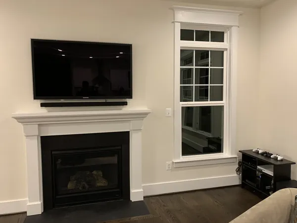 Over-the-fireplace TV mounting with soundbar installation