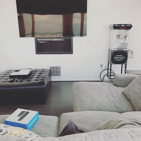 TV mounted above fireplace in a luxury condo media room